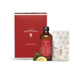 Rote Box mit Flasche, Zitrone und Kr&auml;utern auf hellem Hintergrund.